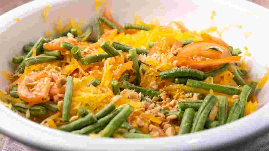 Thai Papaya Salad Recipe:
In a large bowl, add the shredded green papayas, tomatoes, roasted peanuts and the long beans.