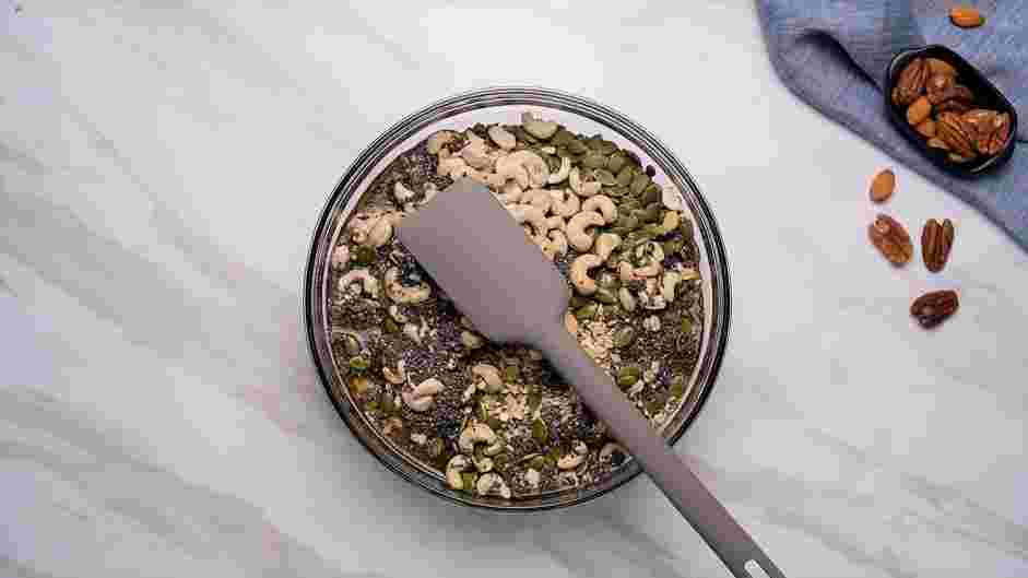 Gluten Free Granola Recipe: In a large mixing bowl, combine the chopped almond and pecans, gluten-free oats, pumpkin seeds, cashews and chia seeds.