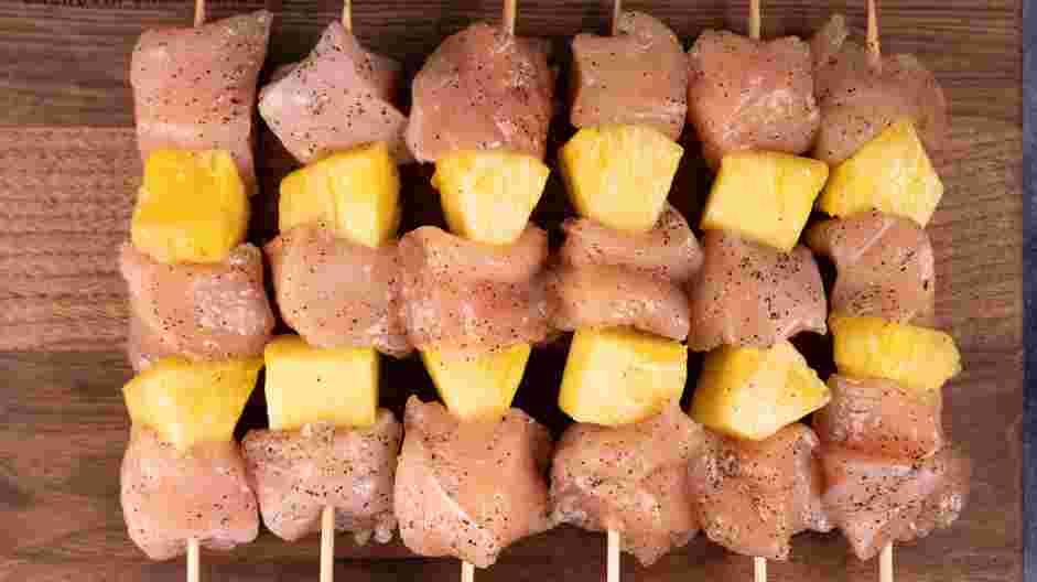 Grilled Pineapple Chicken Recipe: Alternate and thread the chicken and pineapple on skewers.