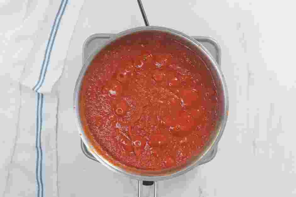 Spicy Vodka Pasta Recipe: Stir in the crushed tomatoes and reduce the heat to low.