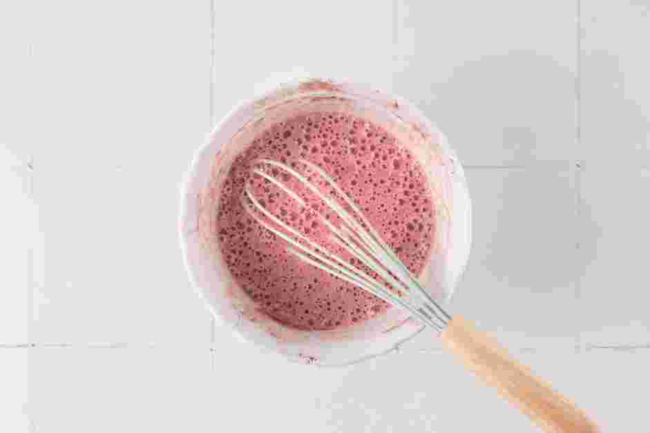 Pink Velvet Macchiato Recipe: Slowly whisk in the hot milk until a smooth pink velvet milk forms and there are no lumps.