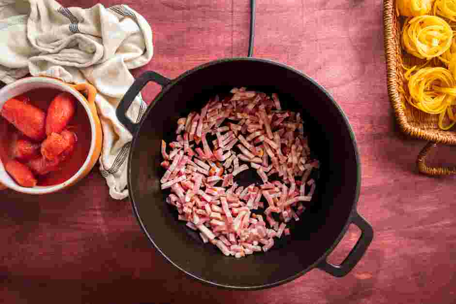 Ragu Alla Bolognese Recipe: In a large pot over medium heat, cook the pancetta or bacon for 5 minutes.