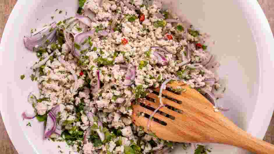 Chicken Larb (Laab Gai) Recipe: Transfer the chicken to a mixing bowl.