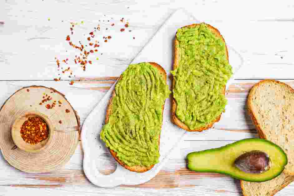 Pesto Eggs Recipe: On each slice of toasted bread, spread the mashed avocado.