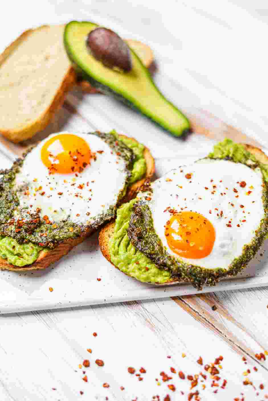 Pesto Eggs Recipe: 
Place one pesto egg onto each slice of bread and top with a sprinkling of red pepper flakes.