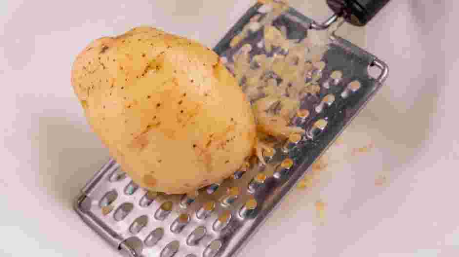 Potato Patties Recipe: 
Wash and grate the potatoes on the coarse side of your grater into a bowl.