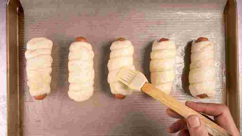 Pretzel Dog Recipe: Brush the dough thoroughly with the egg wash and sprinkle with salt.