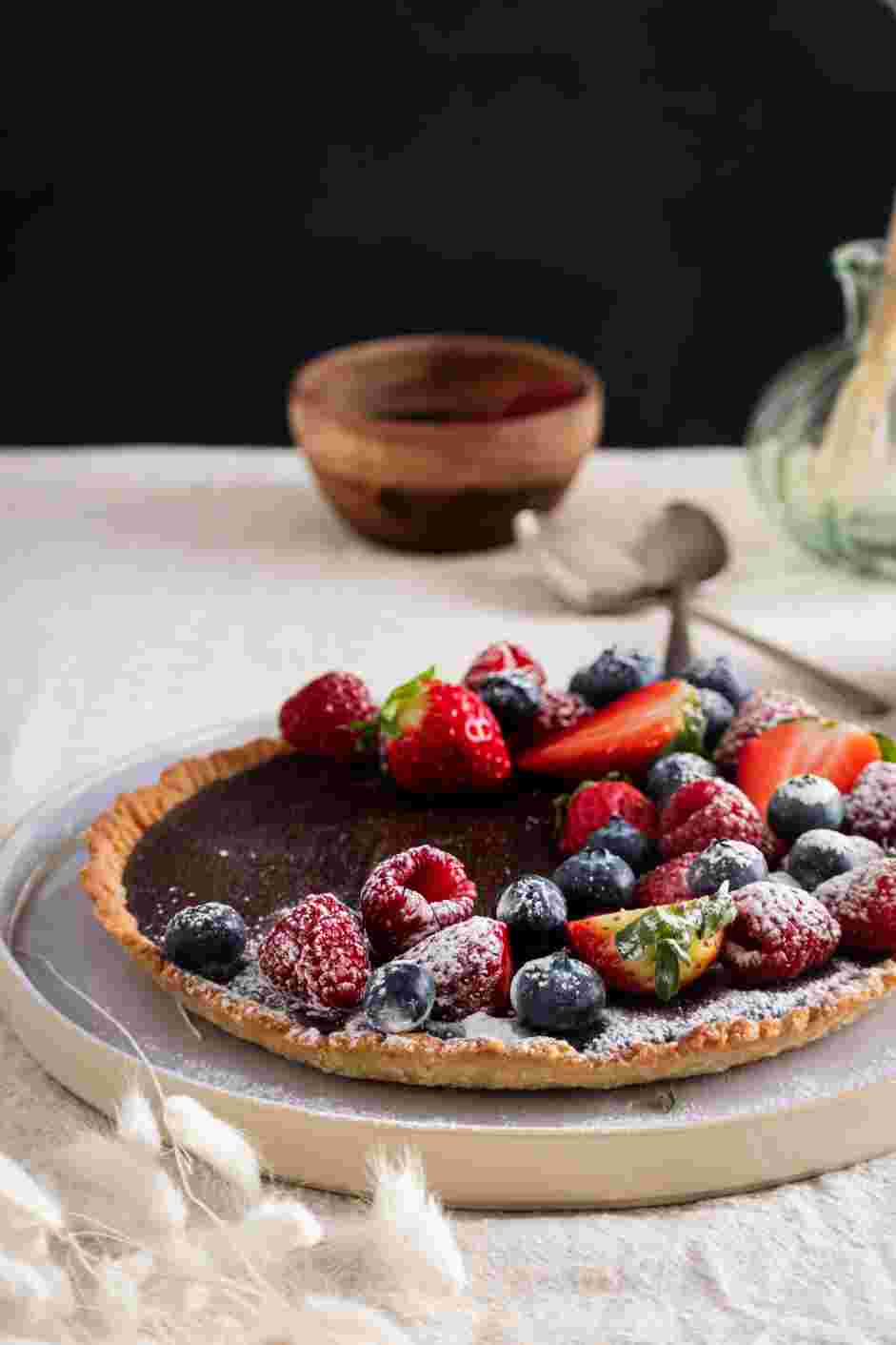 Chocolate Ganache Tart Recipe: Top with raspberries, strawberries, caramel, whipped cream or whatever strikes your fancy.