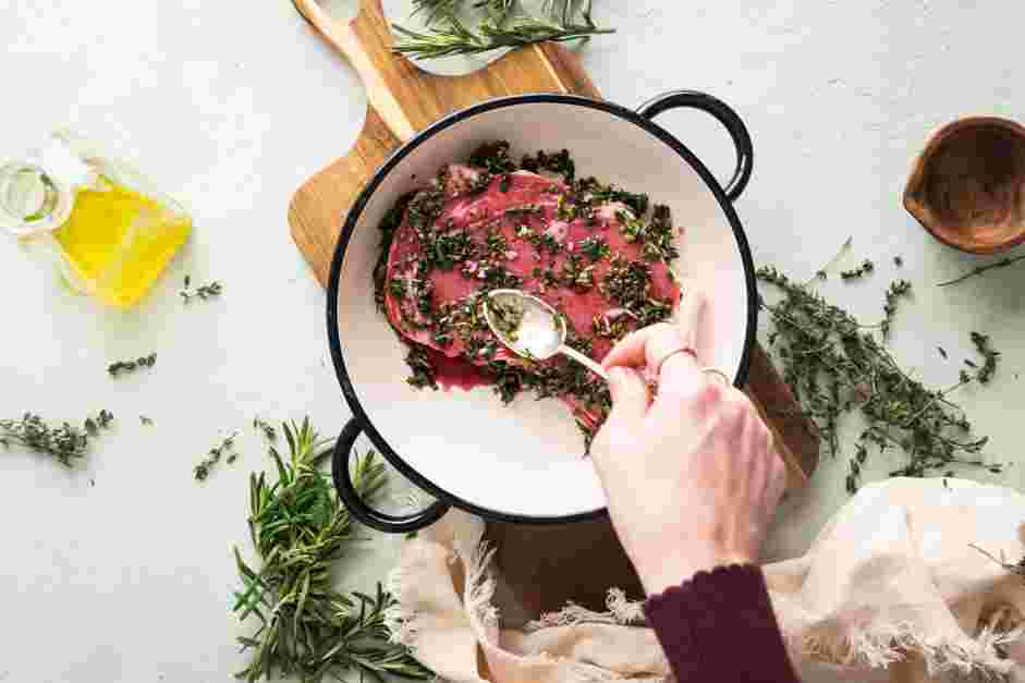 Grilled Flat Iron Steak Recipe: Using plastic gloves, add the flat iron steaks into the bowl and rub the marinade into the steaks.