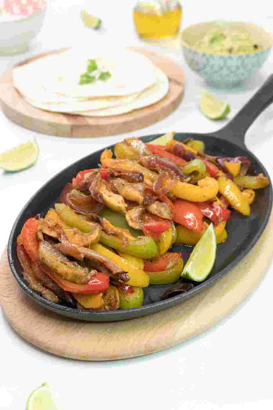 Vegetarian Fajitas Recipe: Top the vegetarian fajitas on a warmed tortilla and serve with guacamole, sour cream, lime wedges and fresh cilantro.