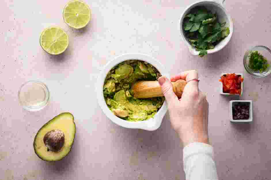 Keto Guacamole Recipe: 
Add the avocadoes to the bowl and gently smash each one against the side of the mortar.