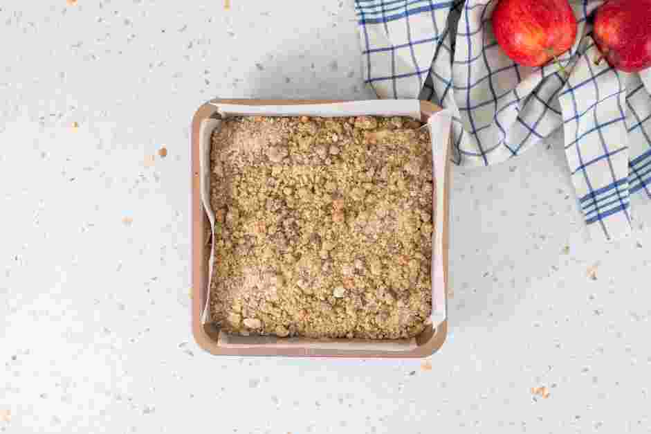 Apple Crumble Cake Recipe: Transfer the batter to the prepared pan and spread it evenly.