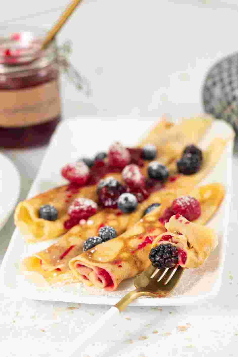 Swedish Pancakes Recipe: Enjoy rolled served with lingonberry jam, fresh berries and dusted with powdered sugar.