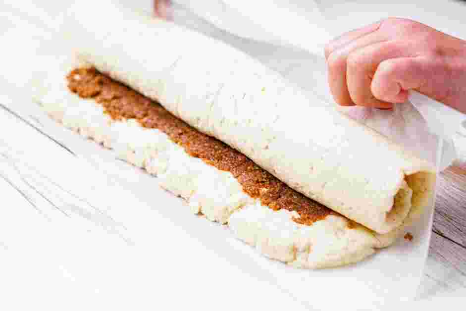 Gluten Free Cinnamon Rolls Recipe:
Starting at the long edge near you, roll up the dough by lifting the parchment paper and pinch the farthest edge to seal.