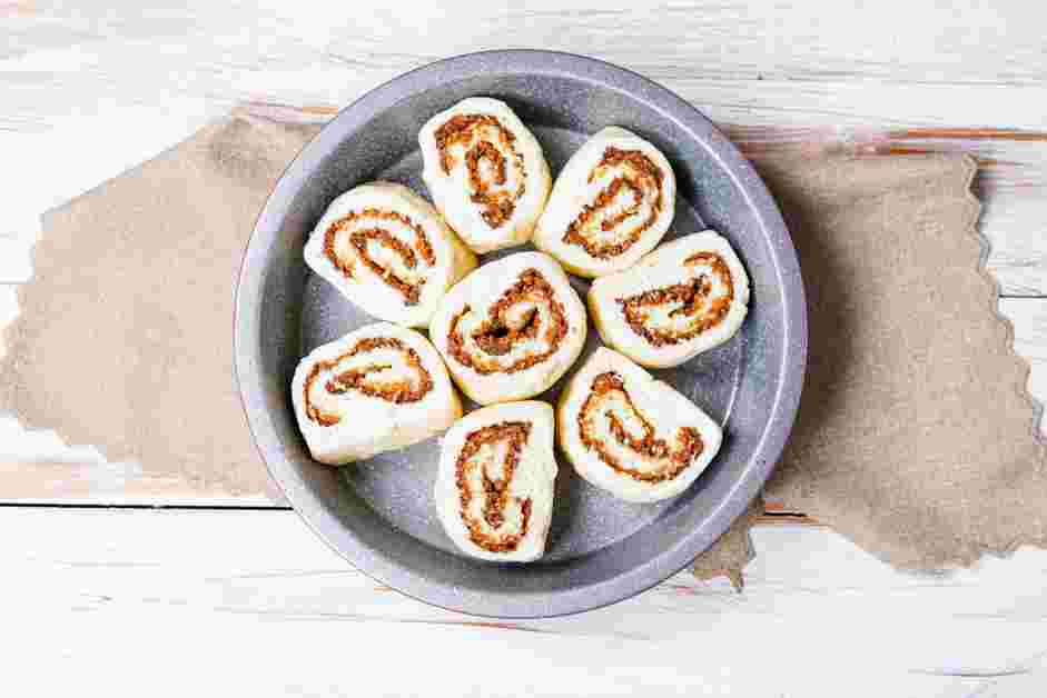 Gluten Free Cinnamon Rolls Recipe: Place one cinnamon roll dough in the center of the pan and the remaining seven pieces of dough evenly around the center dough.