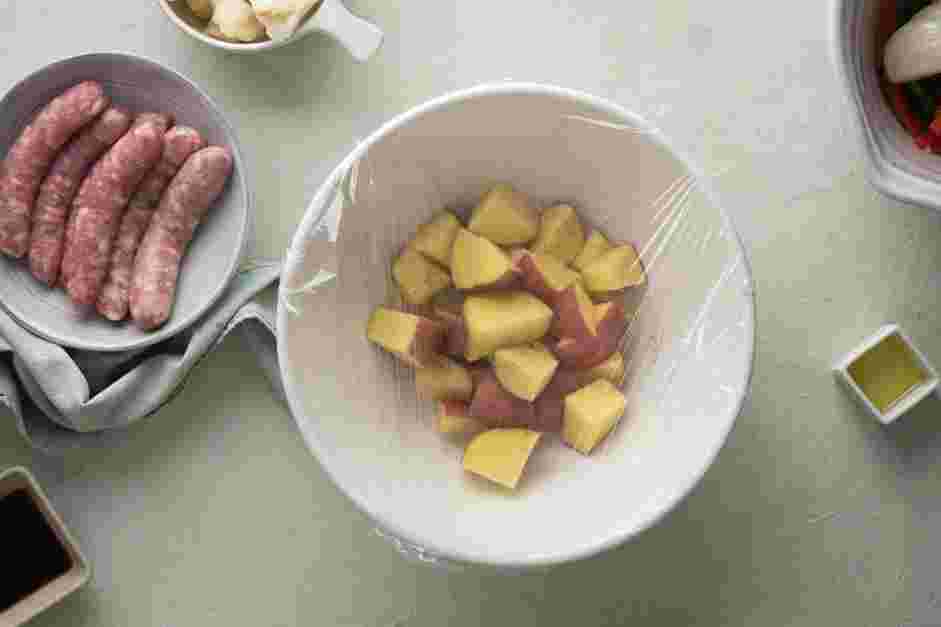 Sheet Pan Sausage and Veggies Recipe:
In a microwave-safe bowl, add the quartered red potatoes, two tablespoons of water, salt and pepper.