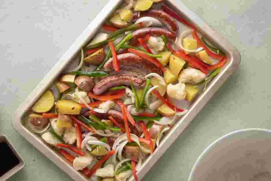 Sheet Pan Sausage and Veggies Recipe:
After 7 minutes, remove the sheet pan from the oven and turn the oven down to 400°F.