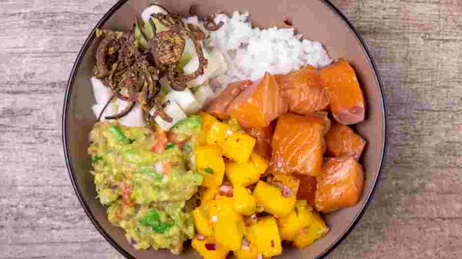 Salmon Poke Bowl Recipe:
Then sprinkle on some diced cucumbers and crispy onions.