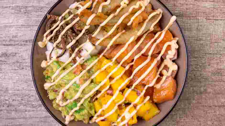 Salmon Poke Bowl Recipe: 
Cut a small hole in the tip of the pastry bag or Ziploc containing the sriracha aioli and drizzle over the bowls.