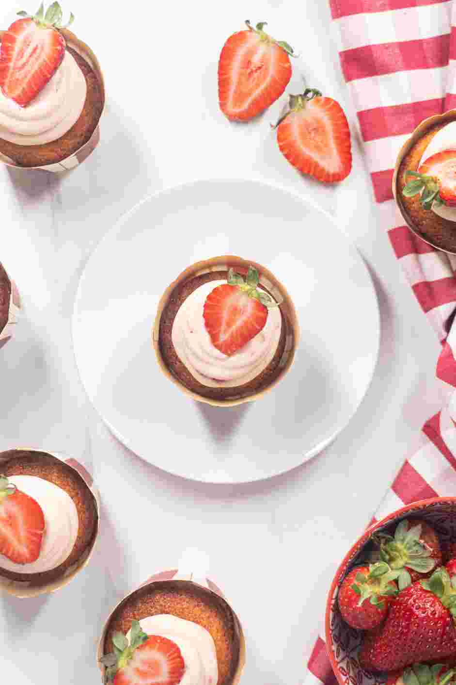 Strawberry Shortcake Cupcakes Recipe: Spread the frosting on the cooled cupcakes, top with a slice of fresh strawberry and serve.