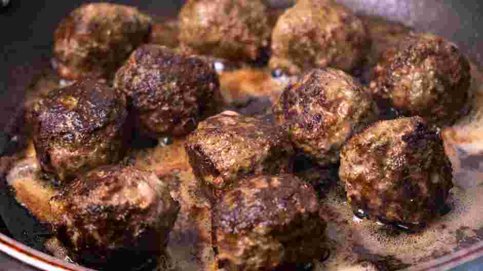 Greek Lamb Meatballs Recipe: In a large cast-iron skillet over medium heat, heat the oil.