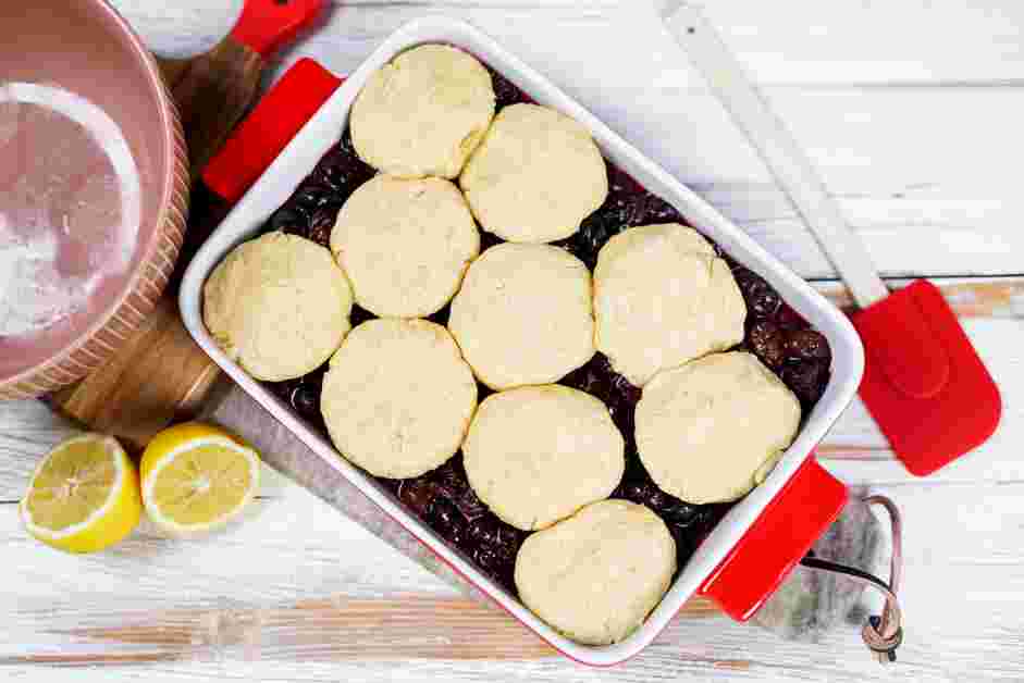 Cherry Cobbler Recipe:
Remove the dough from the refrigerator and arrange the dough balls over the cherries, flattening them slightly to cover most of the cherries in a “cobbled” pattern.