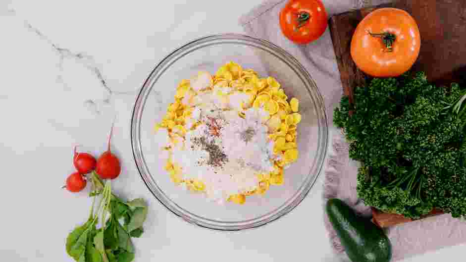 Cornflake Chicken Recipe: In the bowl of a food processor or in a large bowl, pulse or crush the cornflakes, Parmesan cheese, salt, pepper, parsley, smoked paprika, garlic and onion powder together until coarse crumbs form.