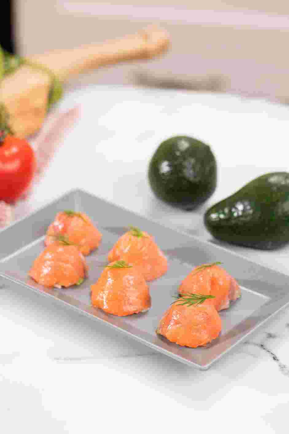 Smoked Salmon Sushi Recipe: Garnish sushi pieces with dill fronds and serve immediately.