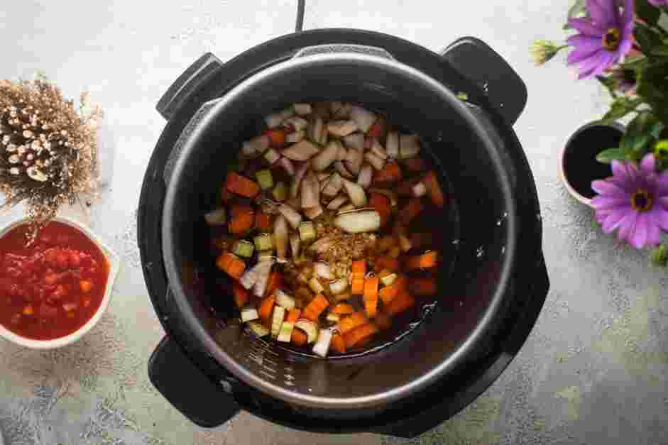 Instant Pot Short Ribs Recipe: Add the chopped carrots, celery, onion, garlic, beef broth, red wine, balsamic vinegar, dried oregano and dried basil to the pot.
