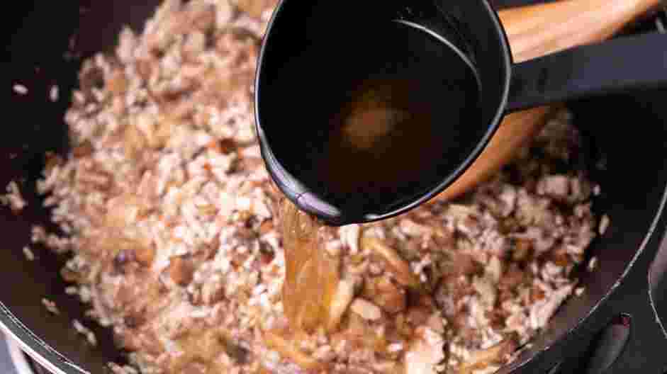 Chicken Mushroom Risotto Recipe: Next, begin to ladle in the hot broth.