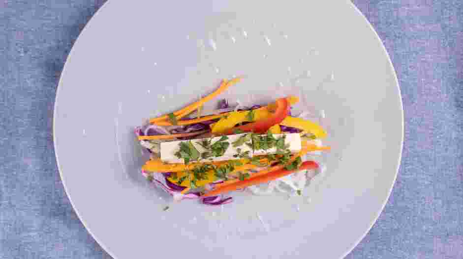 Rice Paper Rolls (Summer Rolls) Recipe:
Place the rice paper roll on a work surface and add a small amount of purple cabbage, cucumber, carrots, red bell pepper, yellow bell pepper and tofu to the bottom third of the rice paper round.