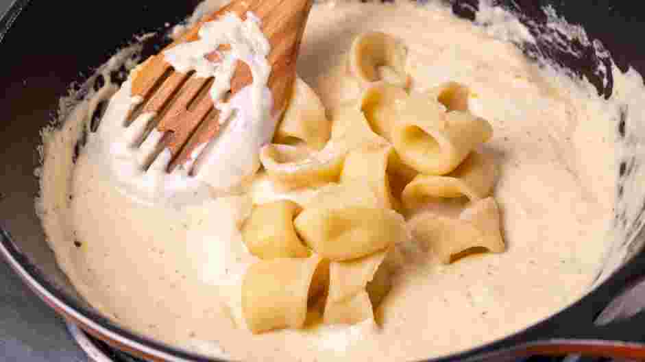 Asiago Tortelloni Alfredo with Grilled Chicken Recipe: Toss the pasta in the alfredo sauce and place on a warm plate.