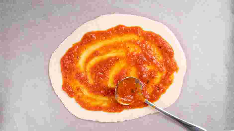 Margherita Flatbread Recipe: Spread tomato sauce evenly over the flatbreads, except for a &frac12; inch border around the edge.