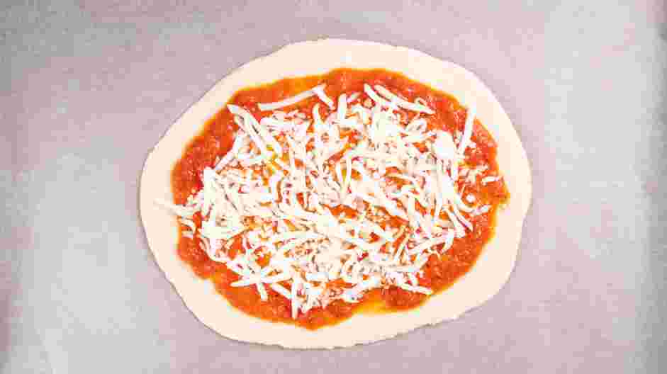 Margherita Flatbread Recipe: Evenly sprinkle the shredded mozzarella between the two flatbreads.