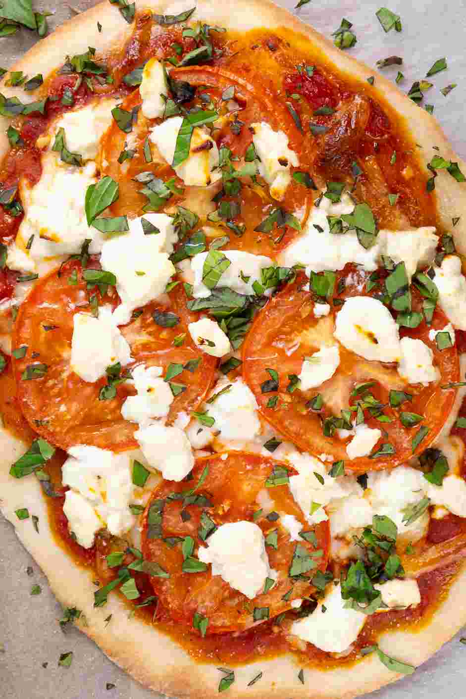 Margherita Flatbread Recipe: Drizzle extra-virgin oil on top of each Margherita flatbread, add the fresh chopped basil and a sprinkle of kosher salt.