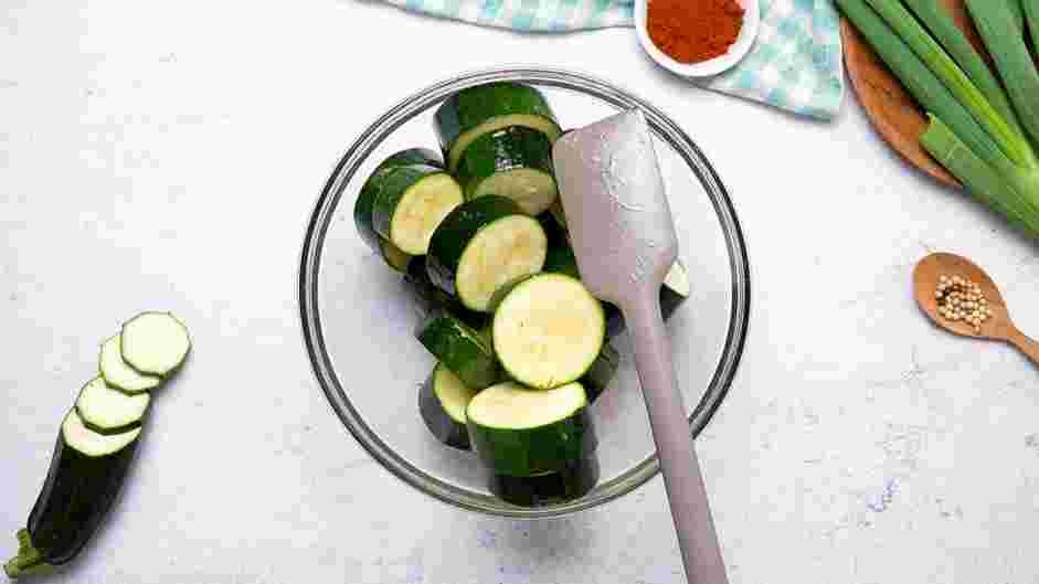 Zucchini Bites with Paprika Greek Yogurt Recipe:
In a large bowl, add the sliced zucchini rounds and extra-virgin olive oil.