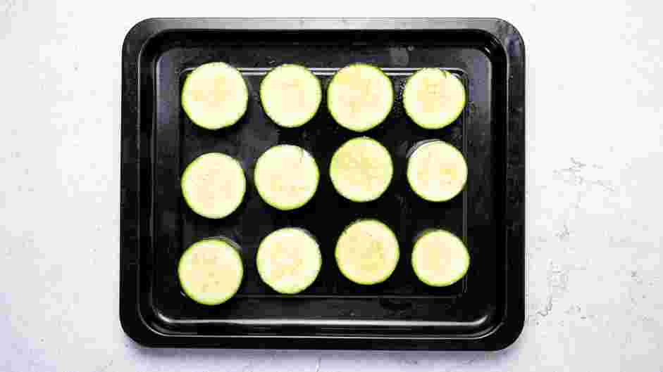 Zucchini Bites with Paprika Greek Yogurt Recipe:
On two sheet pans, place the zucchini rounds in a single layer making sure they do not overlap.