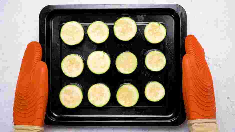 Zucchini Bites with Paprika Greek Yogurt Recipe:
Roast the zucchini rounds for 12 minutes, or until it is halfway cooked.