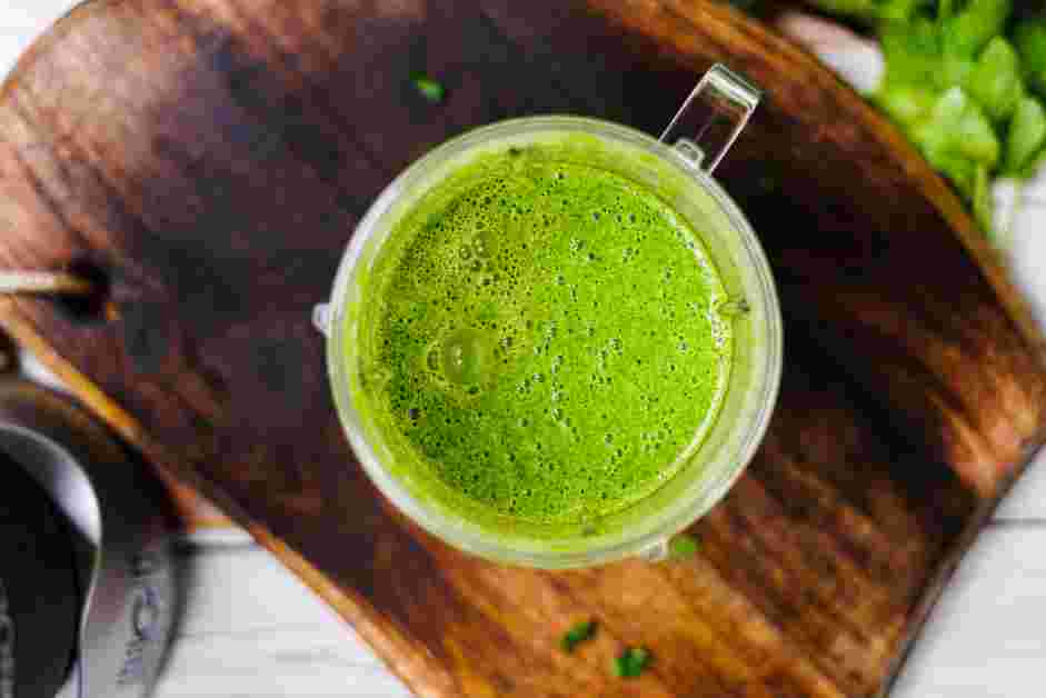 Andhra Chicken Curry Recipe: In the jar of a blender, add the cooked onions and green chili peppers, chopped cilantro, chopped mint and one cup of water.