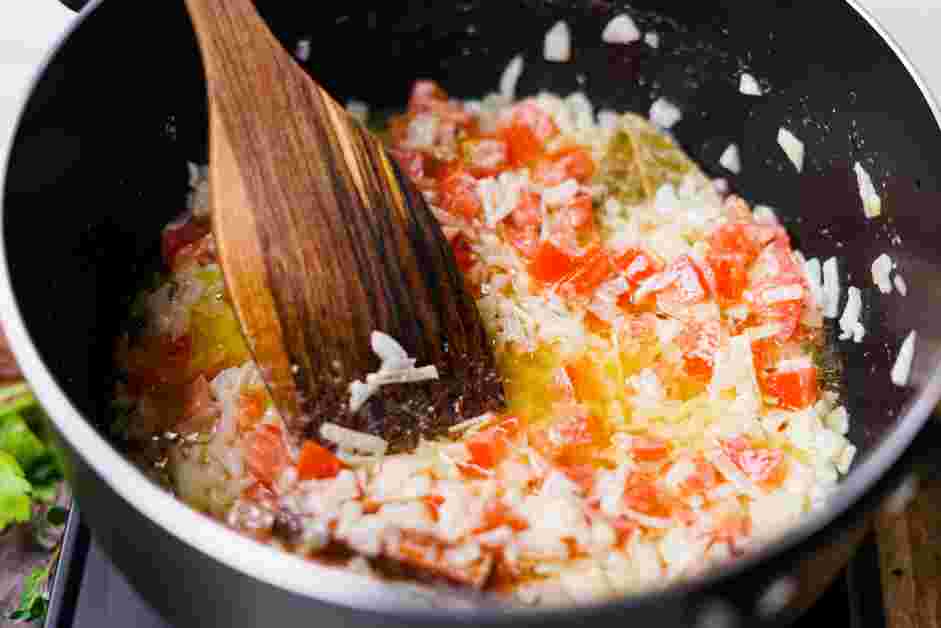 Andhra Chicken Curry Recipe: Add the chopped tomatoes and cook until the tomatoes break down.