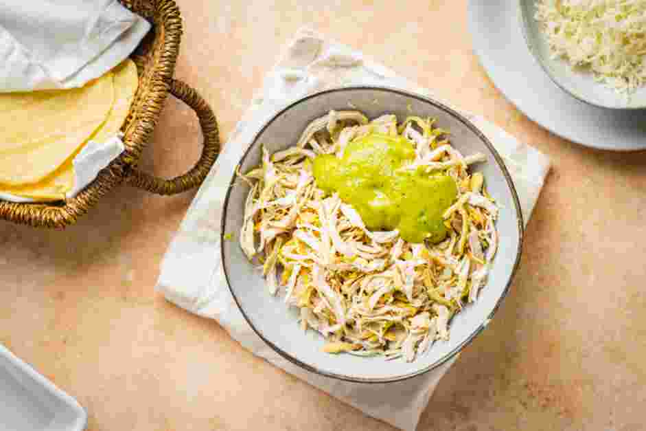 Enchiladas Verdes Recipe: Add about ¾ cup of the salsa verde to the shredded chicken and set the remaining sauce aside.