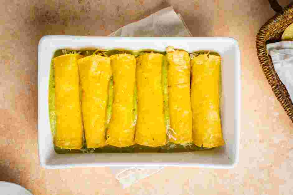 Enchiladas Verdes Recipe: Roll the tortilla and place seam side down on the prepared baking pan.