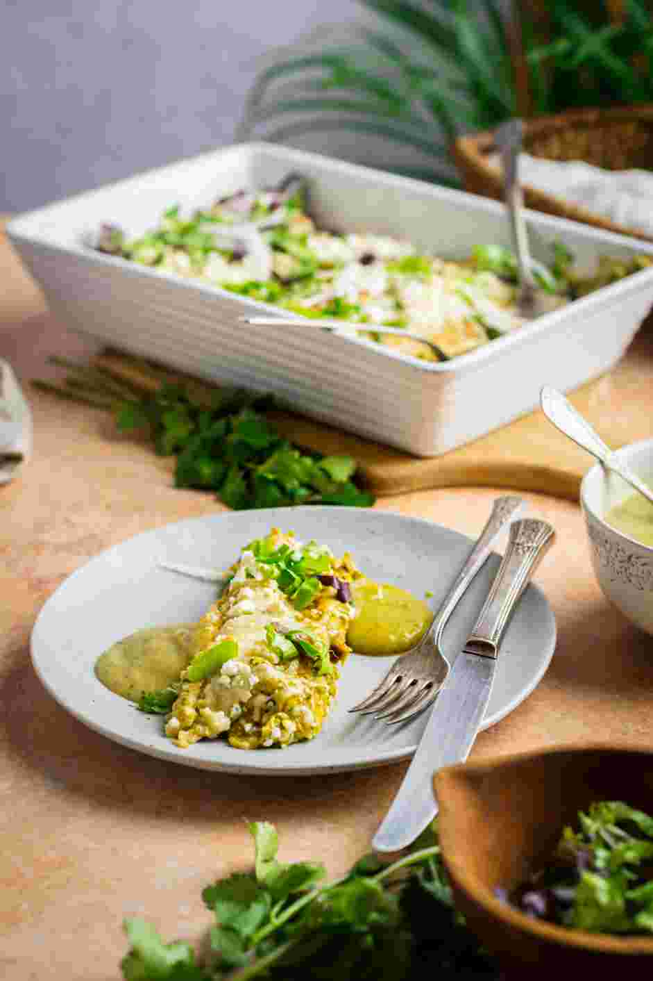 Enchiladas Verdes Recipe: Serve topped with salsa verde, shredded lettuce, thinly sliced onions, cojita cheese and fresh cilantro.