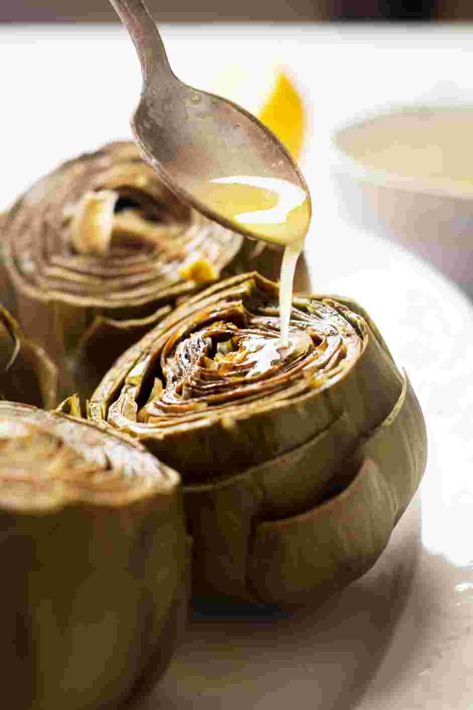 Instant Pot Artichokes Recipe: Dip the leaves into the lemon sauce and enjoy!