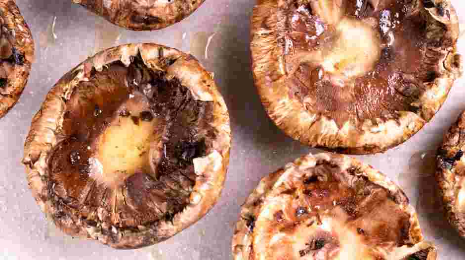 Crab Stuffed Portobello Mushrooms Recipe: Line up the cleaned portobello mushroom caps on the prepared baking sheets.