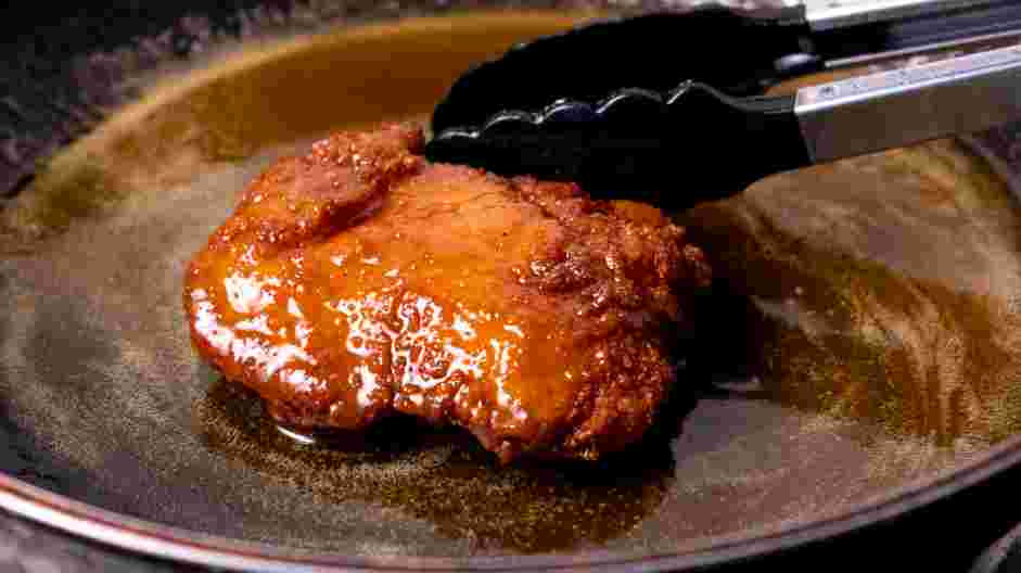 Honey Fried Chicken Recipe: Transfer the honey butter into a large bowl and add the fried chicken.