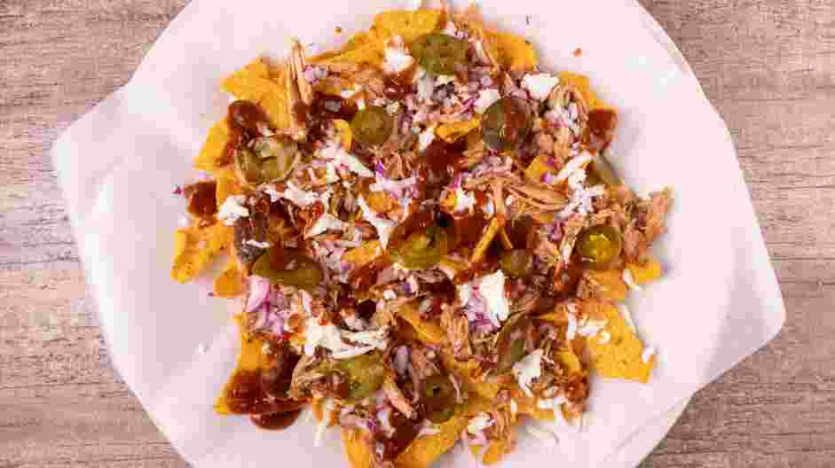 Pulled Pork Nachos Recipe: Drizzle the barbecue sauce over the nachos.