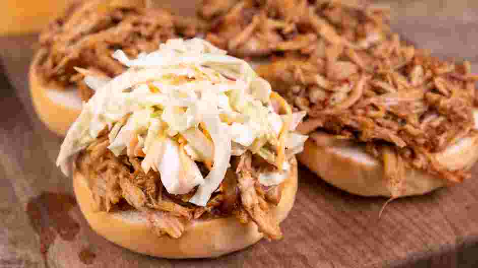 Pulled Pork Sliders Recipe: Top with the crunchy coleslaw.