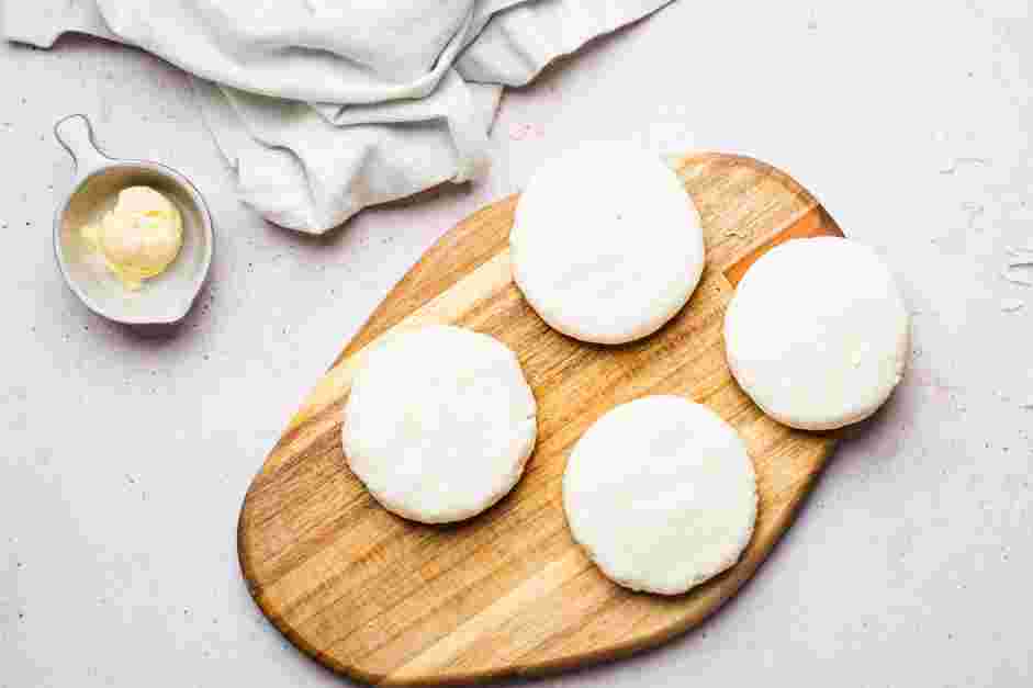 Arepa con Queso (Cheese Arepa) Recipe: Close the indentation and use your palms to flatten the ball of dough into a &frac14;-inch disc.