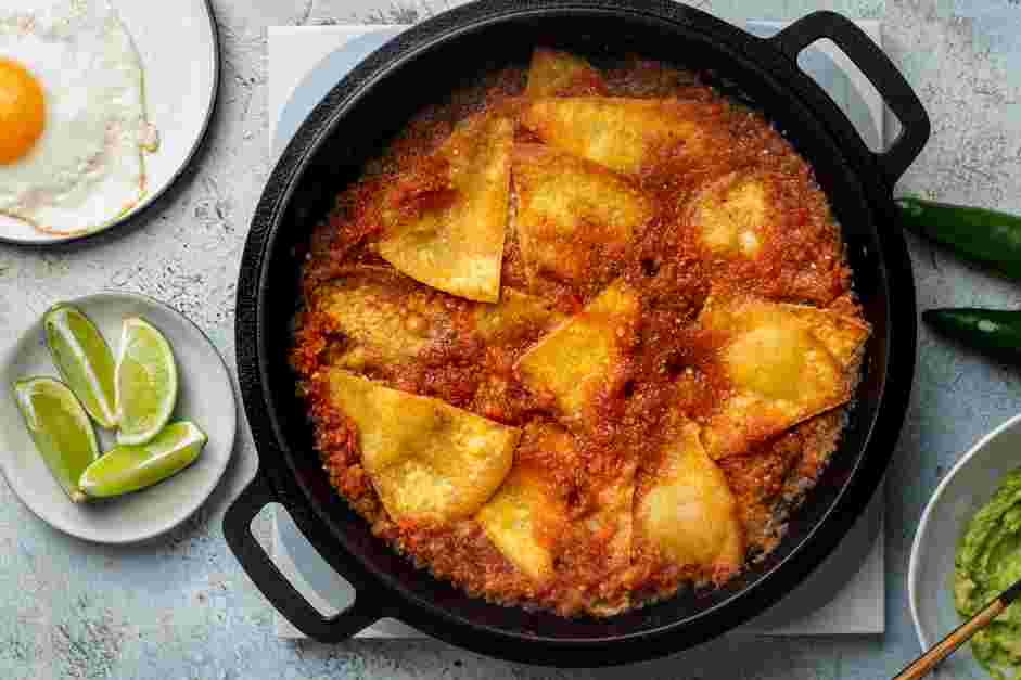 Chilaquiles Rojos Recipe: Once the sauce is hot, add the fried tortilla wedges and coat each one with the sauce on both sides.